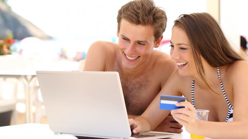 Use travel rewards to your advantage. couple typing in credit card info