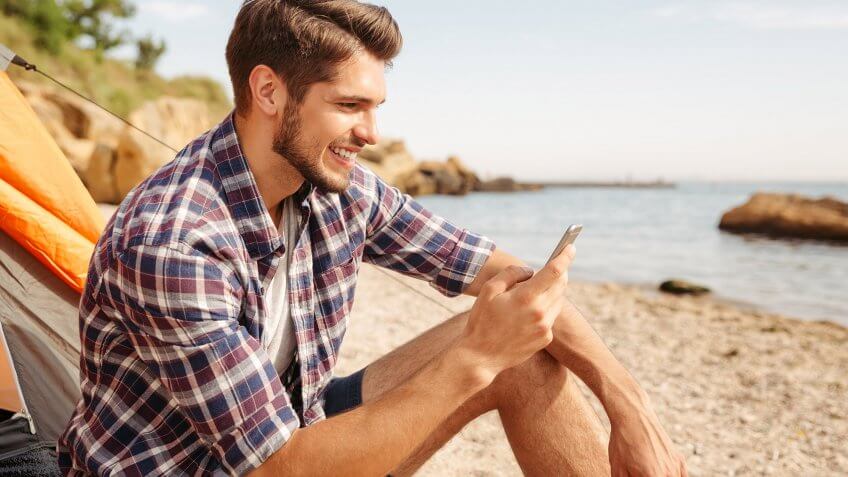 Avoid Wi-Fi connections in public places. man on phone at the beach
