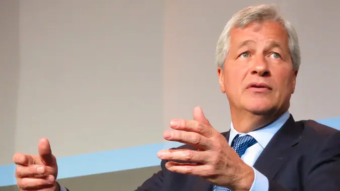 JP Morgan's CEO Jamie Dimon seated in a suit giving a talk.