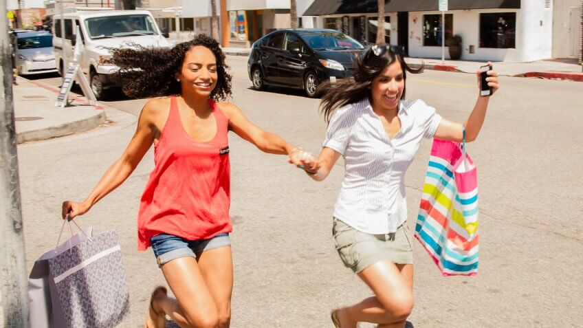 Shopping and Consumerism: Excited friends shop together.