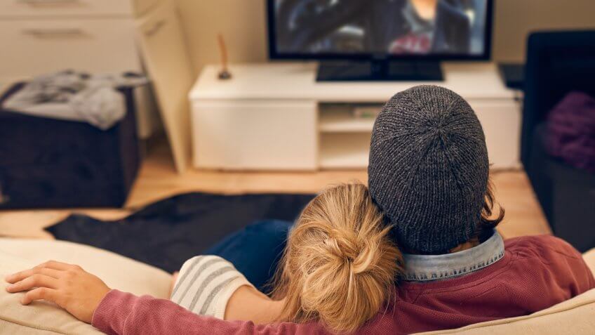 Couple watching TV together Couple watching TV together