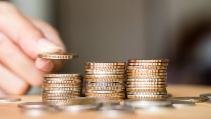 person stacking coins