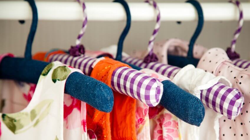 bright colorful dresses on clothes hangers