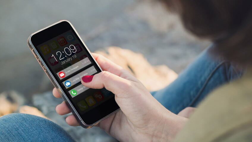 Set up credit report push notifications. woman holding iphone