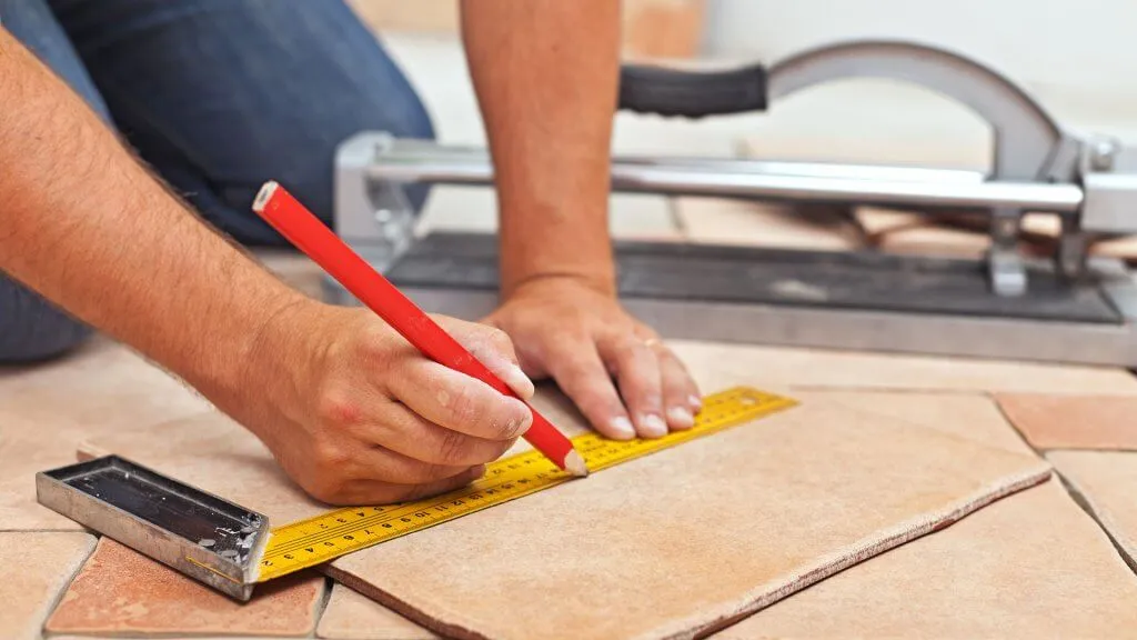 contractor making measurements on floor tile