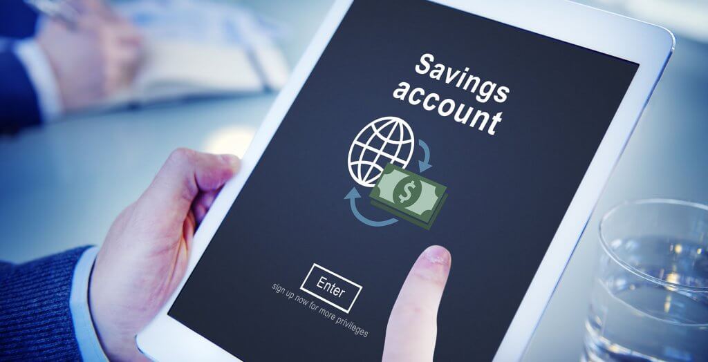You should only change your savings account number in certain circumstances. man signing up/logging in to savings account on tablet