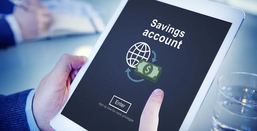 man signing up/logging in to savings account on tablet