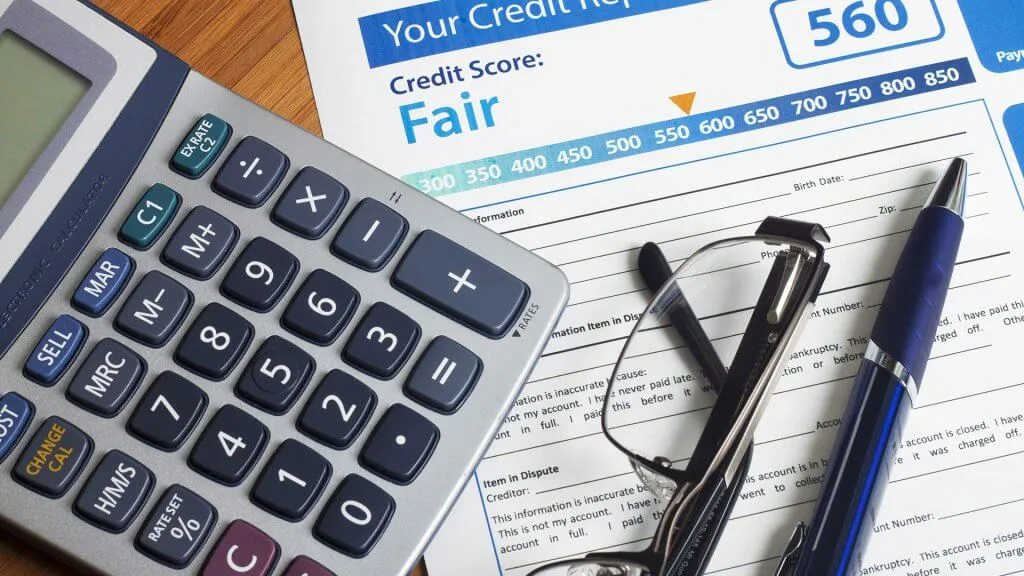 fair credit report with calculator glasses pen