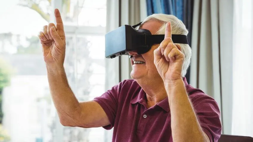 old man wearing vr headset and pointing up