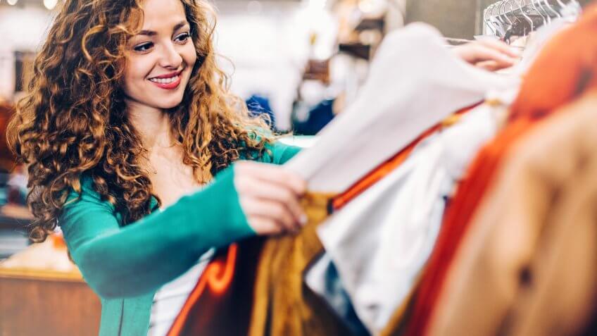 Happy young woman in a fashion store.