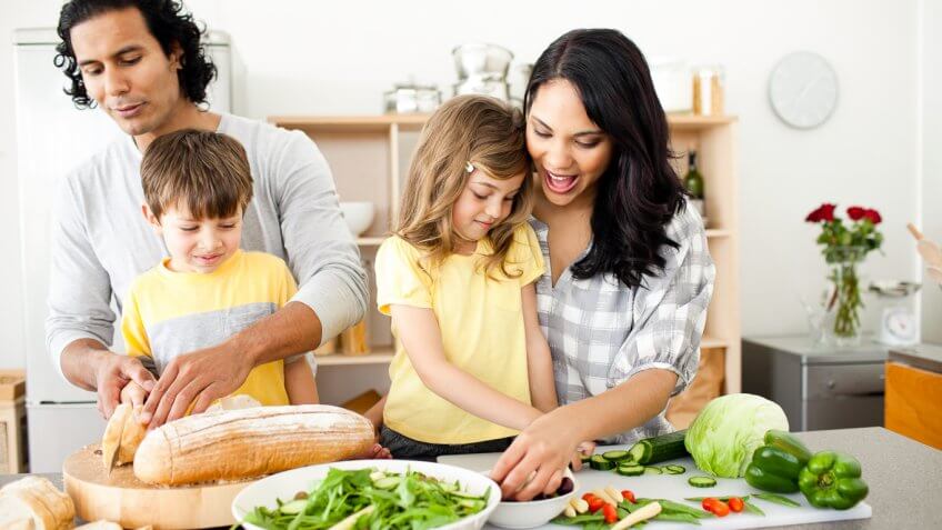 family cooking a healthy dinner together