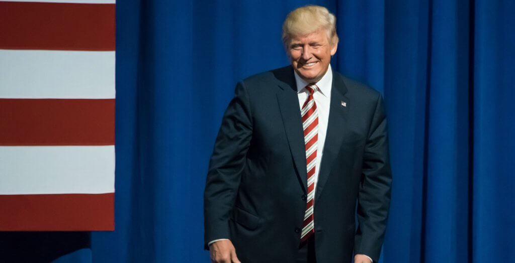 Trump wants to lower taxes for corporations and individuals. donald trump on stage