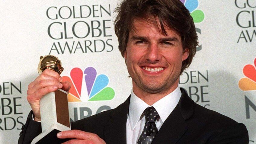 Tom Cruise holding Golden Globe Award