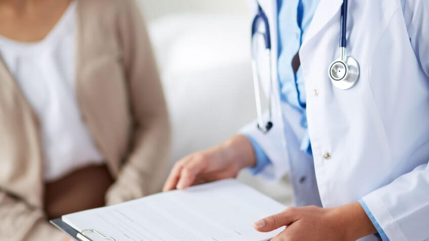 Lower-income adults have the most medical debt. doctor with patient's medical records