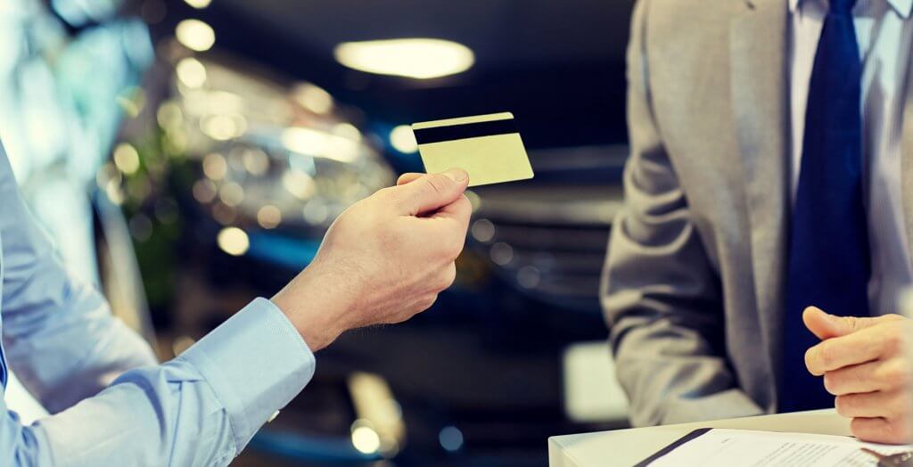 Credit cards keep you a little safer from identity theft. person handing credit to card to man