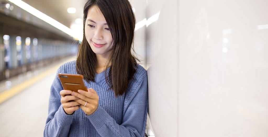 It is easier to manage payments. woman in subway station on phone