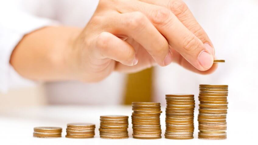 If you're self-employed, consider an SEP IRA. person stacking coins in rows of various height