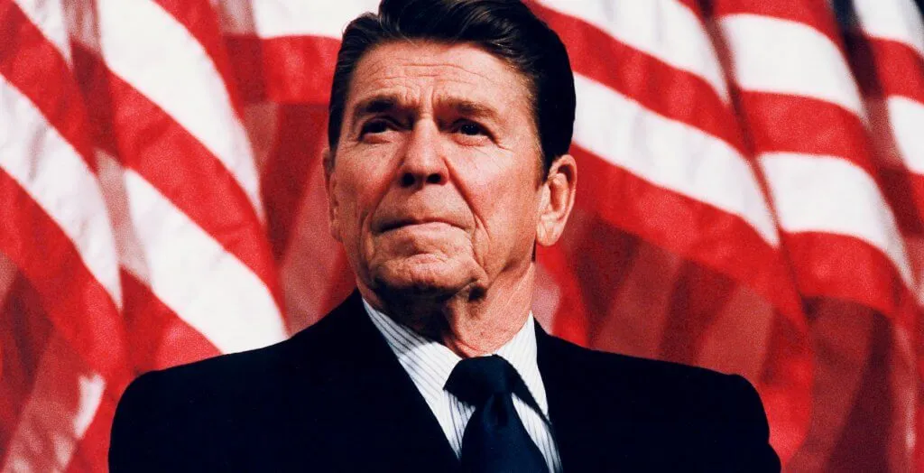 ronald reagan posing in front of the american flag