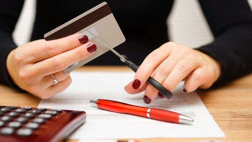 woman cutting up credit card