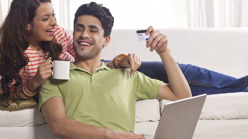 Zero percent interest is your friend. couple laughing on couch