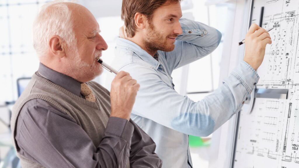 two men reviewing floor plans