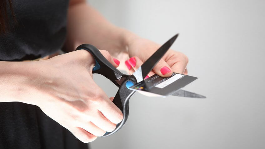 You don't use a credit card. woman cutting up credit card
