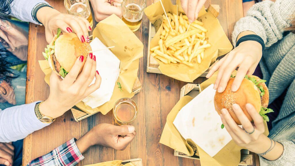 Avoid eating out. people consuming burgers fries and beer