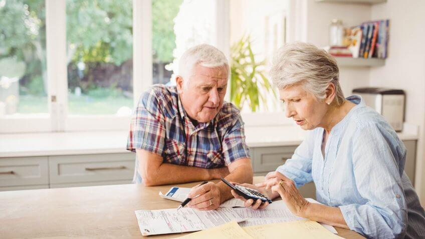 elderly couple working on finances