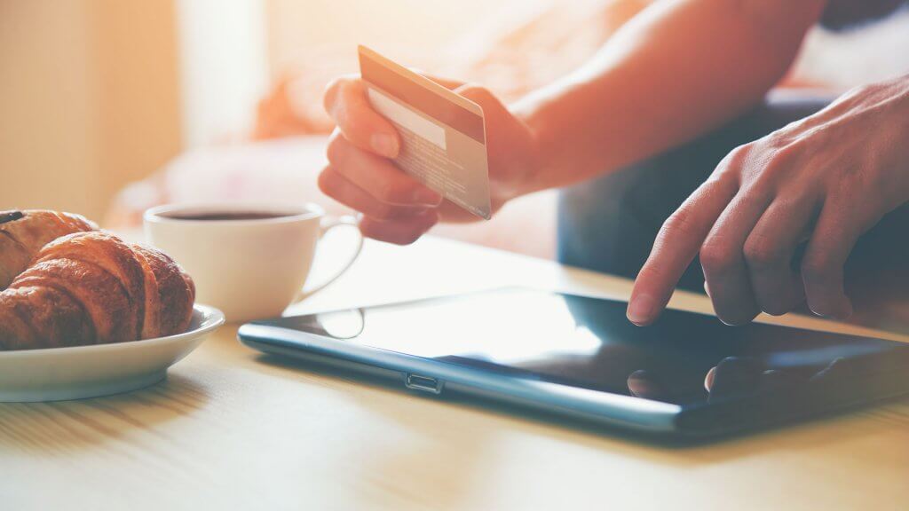 You'll have predictable payments. person entering credit card info into tablet