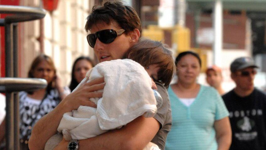 Tom Cruise holding daughter