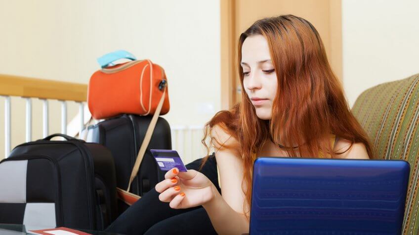 Use prepaid cards. woman entering credit card info into laptop