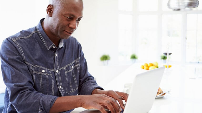 Tax-loss harvesting can help you save even more. man typing on laptop