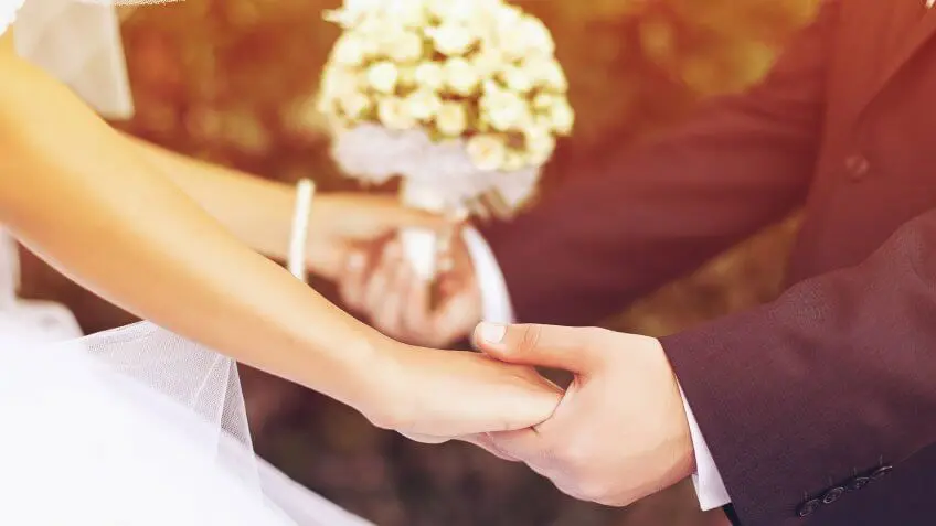 bride and groom holding hands