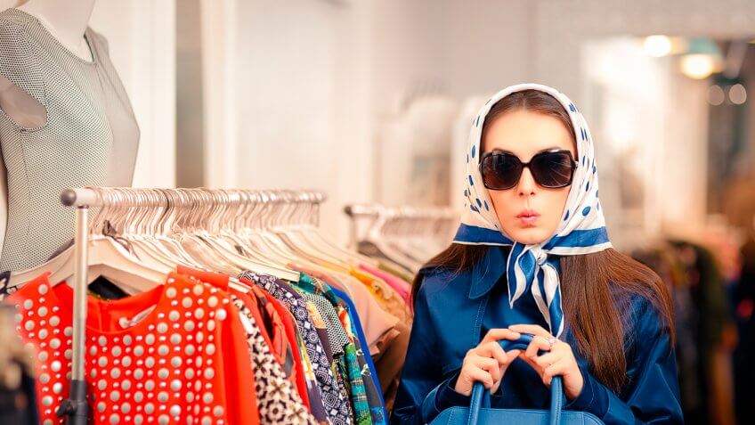 mysterious looking woman with head garb and sunglasses on inside store