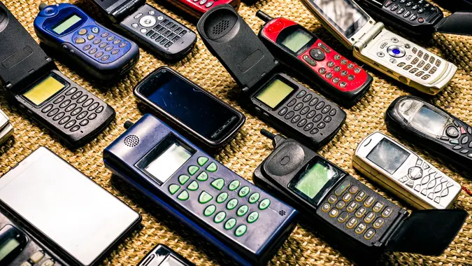 collection of old used mobile phones without logos and labels.