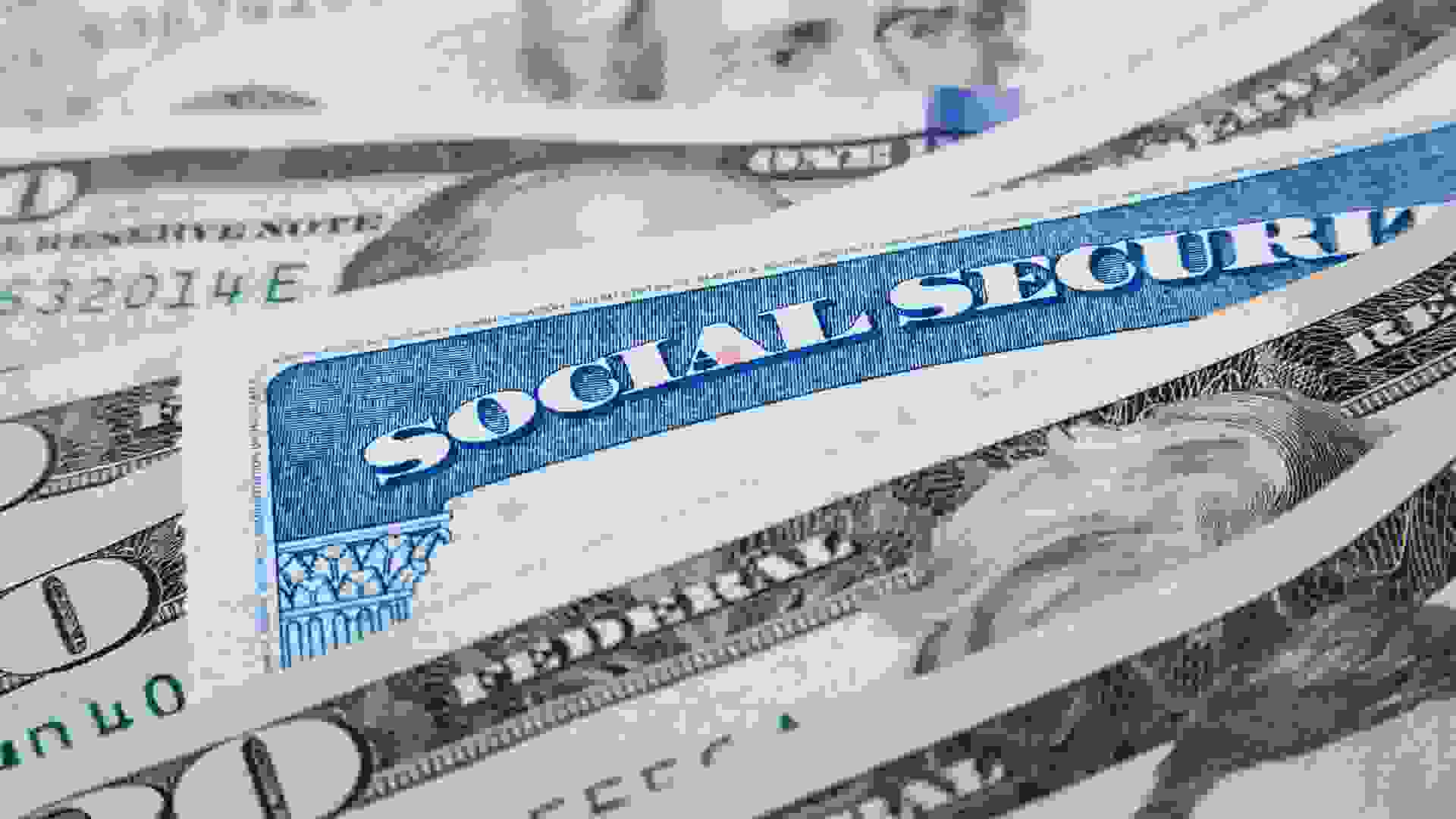 Social security card and American money dollar bills close up concept.