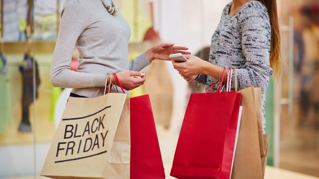 It's best to stick to your Black Friday shopping list. two women shopping black friday sales