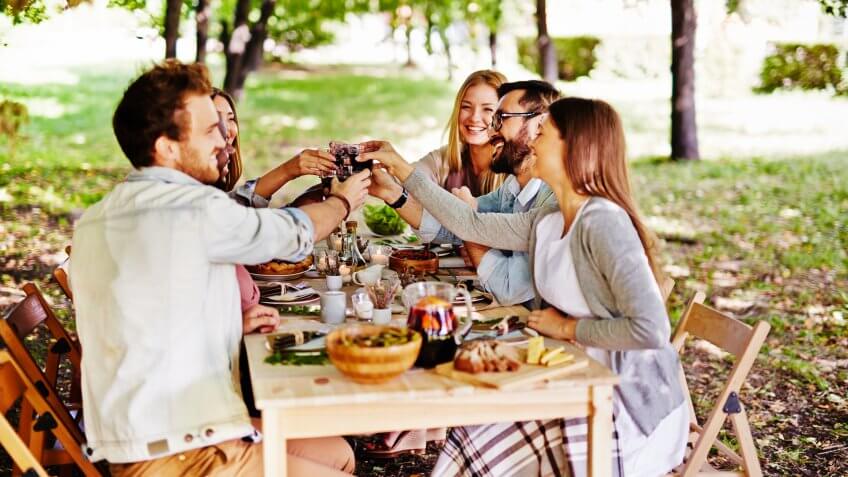 friends enjoying meal in a park