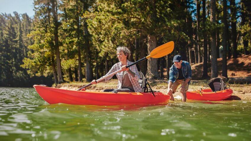 Senior couple having fun kayaking in the lake.