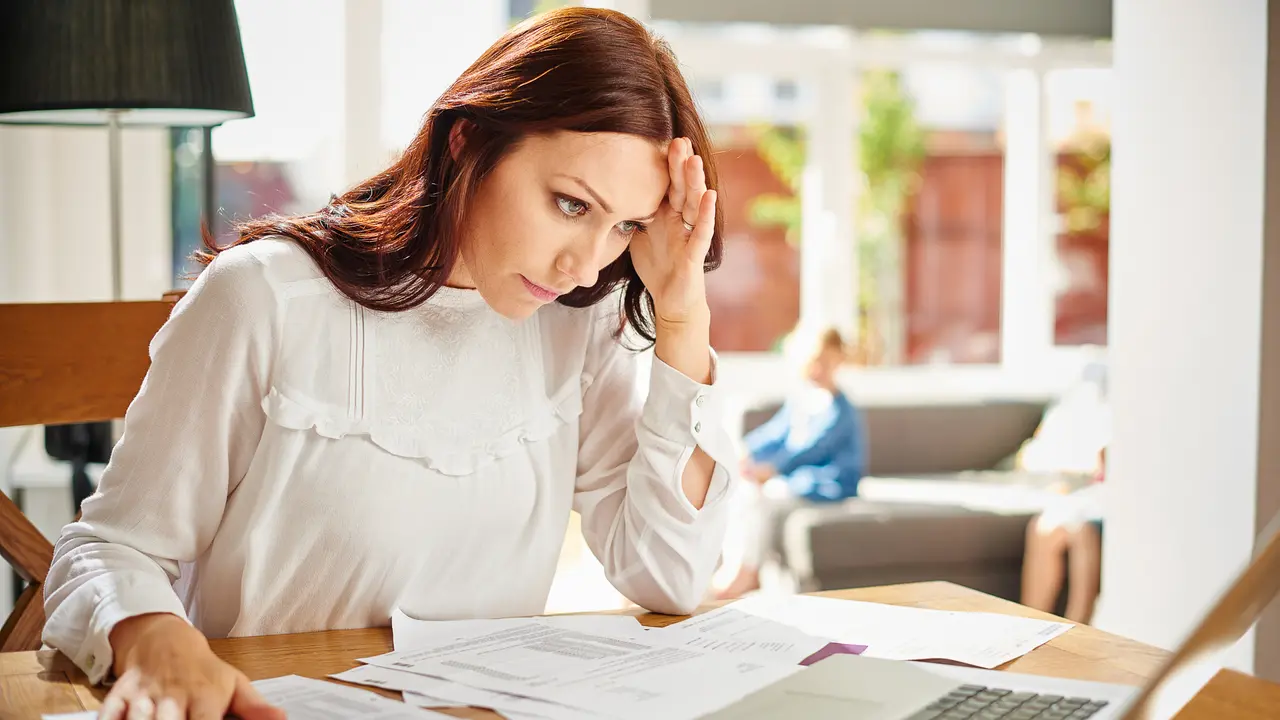 woman frustrated at paperwork