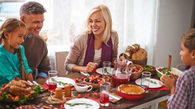 Happy family of four celebrating Thanksgiving day.