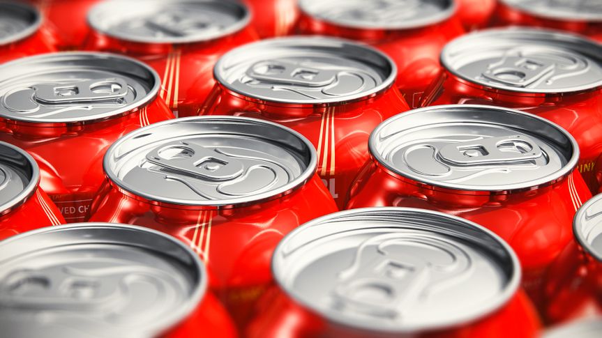 Macro view of color drink tin cans with cola soda beverage with selective focus effect.