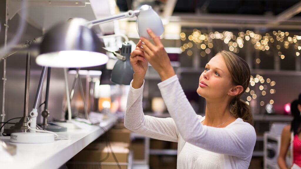 Quality Issues woman inspecting ikea lamp