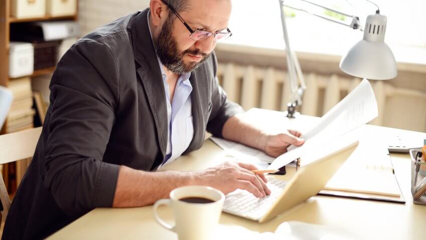 Mature Adult man working in the office.