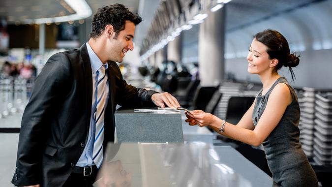 Business man traveling and doing check-in at the airport.