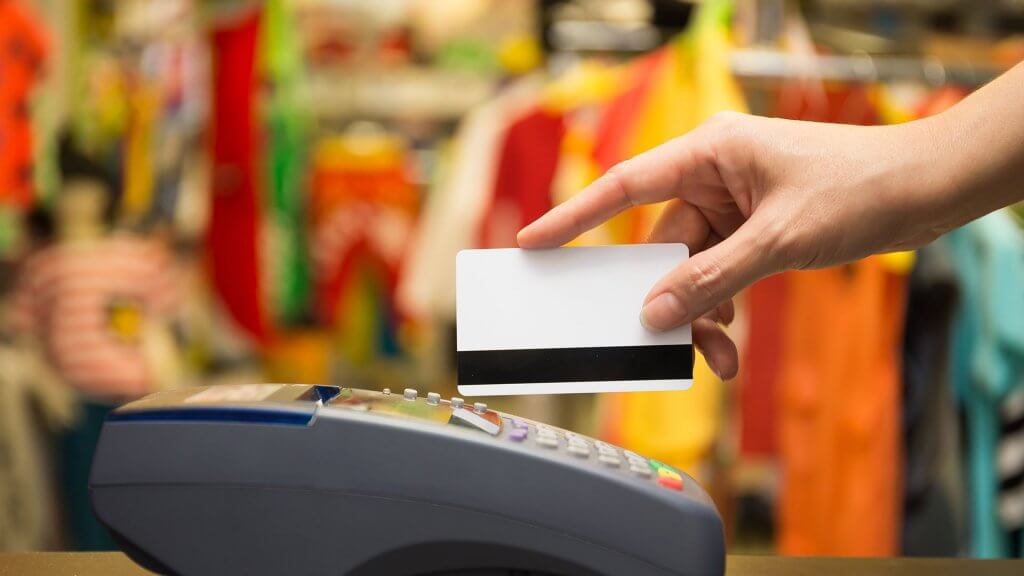 Dont Max Out Credit Cards person swiping credit card