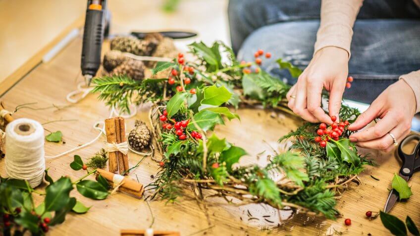 Family preparing advent wreath for Christmas.