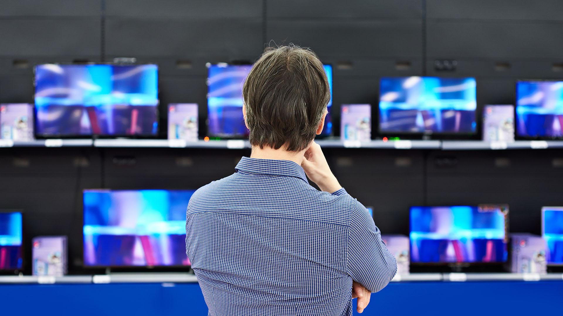 man shopping for TVs