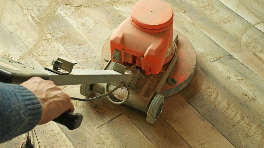 Refinish your hardwood floors. person operating floor sander
