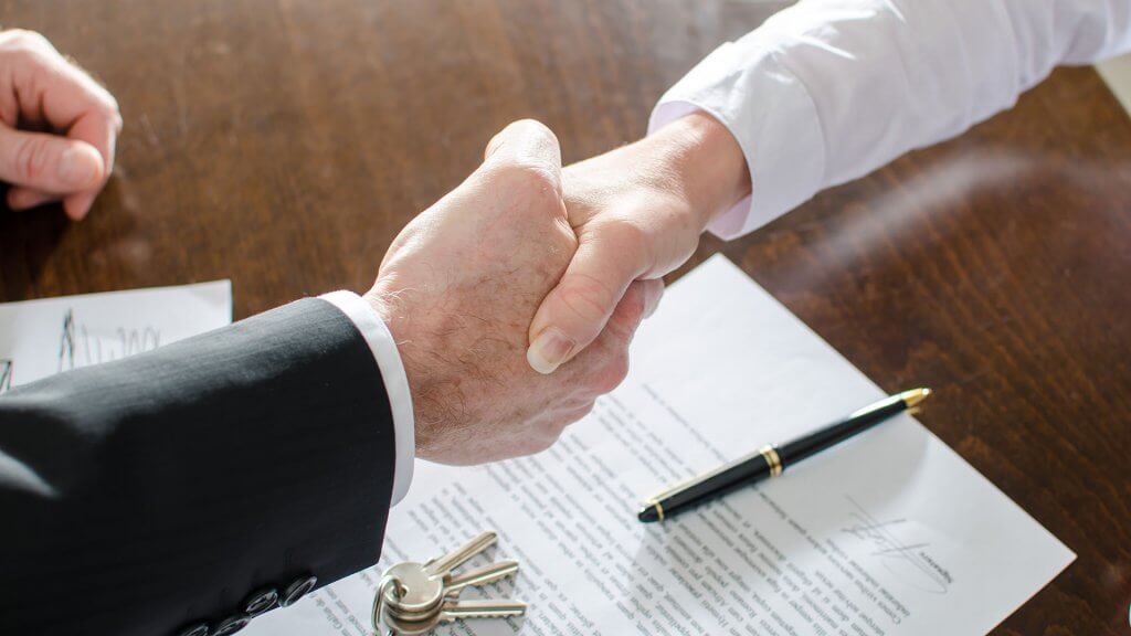 Resist the Urge to Take Out Loans to Pay for the Holidays two people shaking hands
